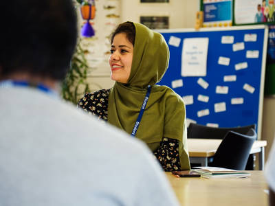 Adult learner listening and engaging in a classroom discussion.