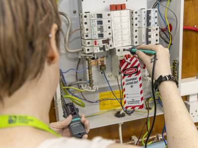An electrical student testing a switchboard 
