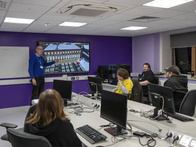 Students sitting in a computing classroom listening to a lecturer 