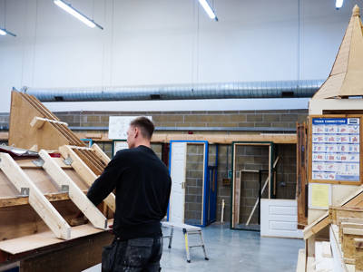 A male carpentry and joinery student in the learning space at City of Portsmouth College 