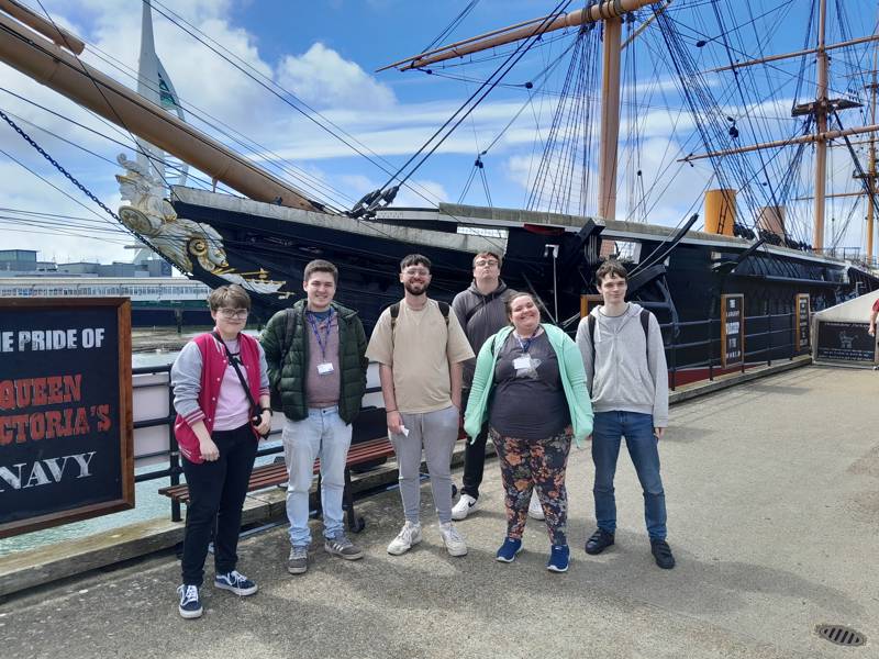 A Prince's Trust team stood in front on HMS Warrior in Old Portsmouth.