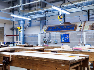A woodwork classroom full of working benches at City of Portsmouth College 