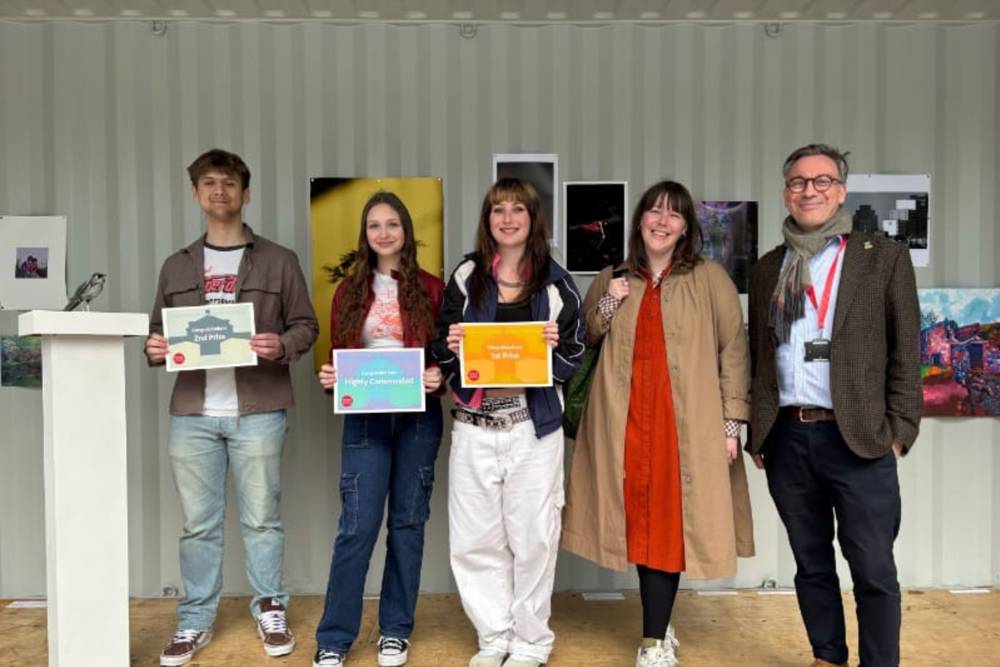 Solent Art Competition winners holding up their certificates.