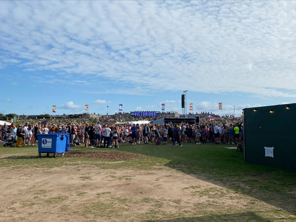 Crowds of people enjoying the Victorious Festival in Portsmouth on a sunny day.