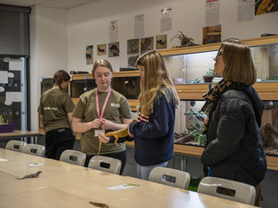 A student and two visitors in an animal care classroom at City of Portsmouth College 