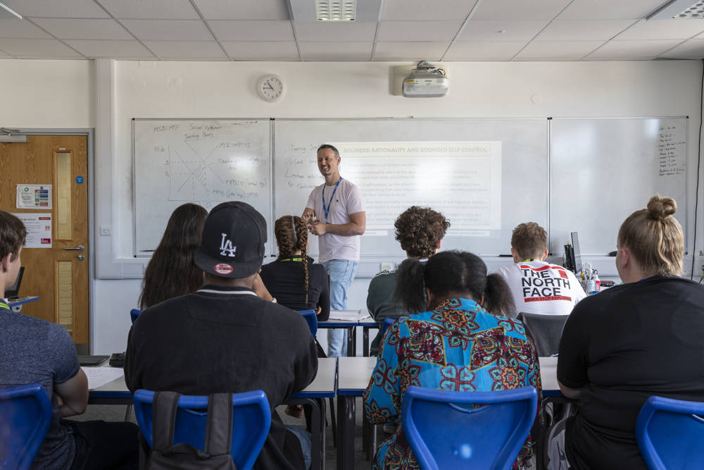 A social sciences lecturer presenting to his class