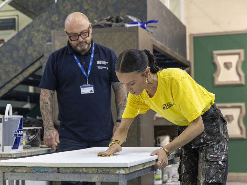 A painting and decorating student sanding at City of Portsmouth College 