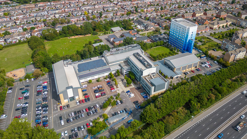 Highbury Campus at City of Portsmouth College with main teaching buildings, car park and surrounding residential area.