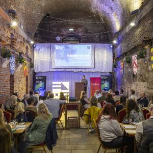 guests at the COPC and Unloc community dinner hearing from guest speaker Motaz Amer
