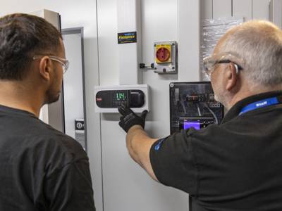 A lecturer and student working in the refrigeration workshop 