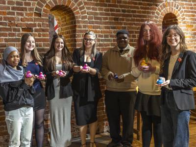 COPC student ambassadors who helped at the event, holding up rubber ducks won in a Hook A Duck competition