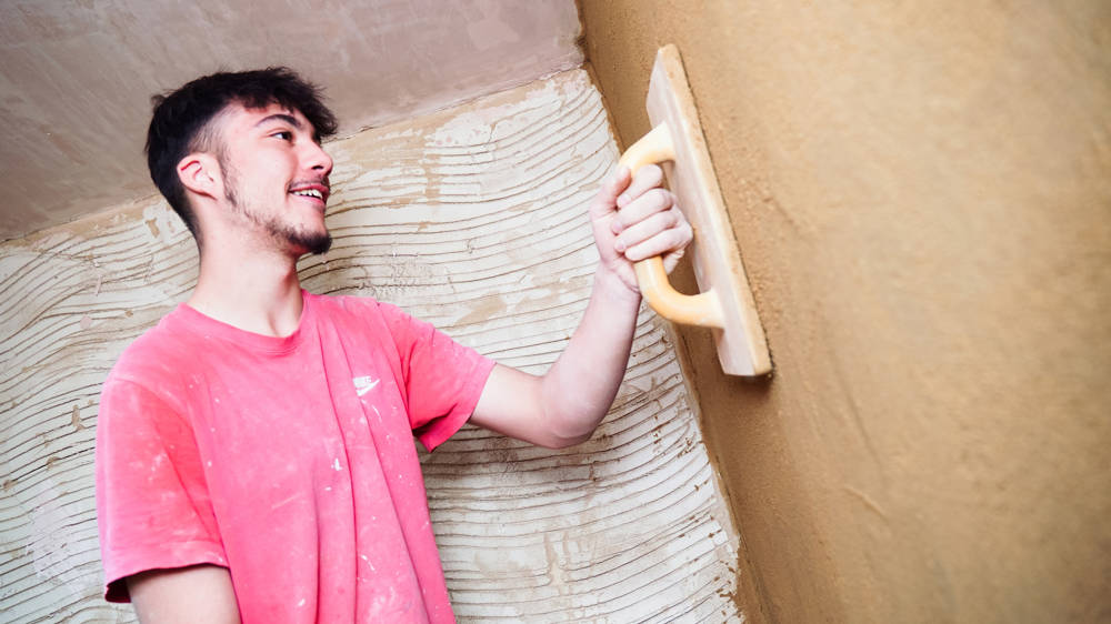 Plastering student working with plastering materials in the workshop at North Harbour campus